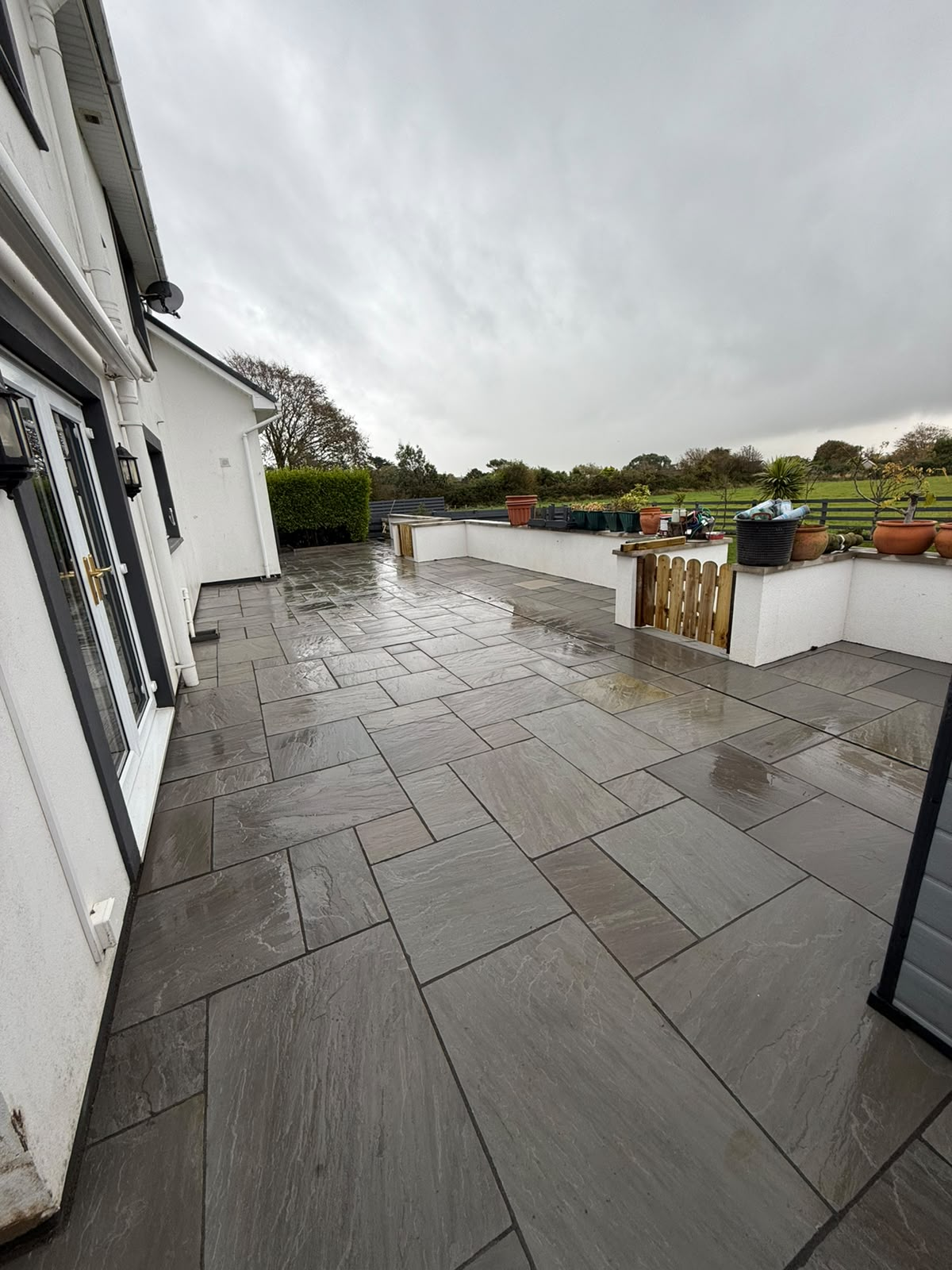Premium patio and landscaping transformation — large-format paving, Isle of Man