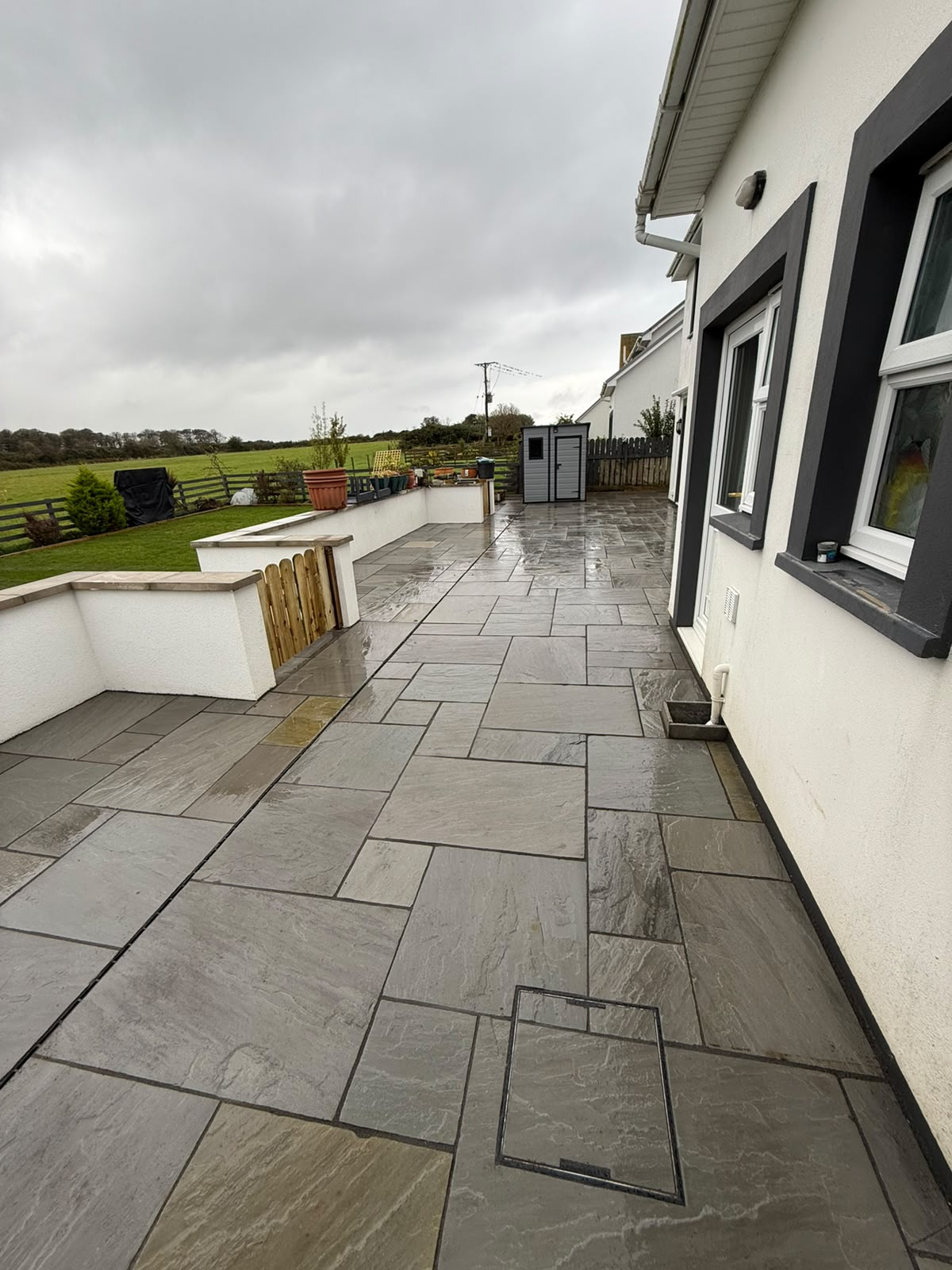 Patio paving with retaining walls and improved garden access, Isle of Man