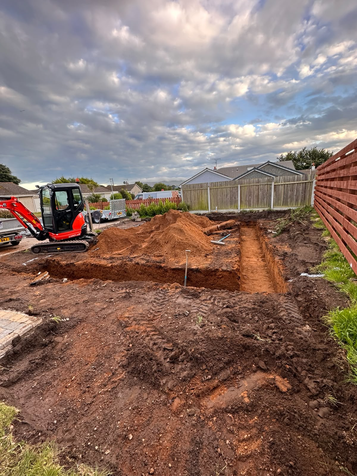 Excavation and foundation trenches dug out and set to level for a detached triple garage, Isle of Man