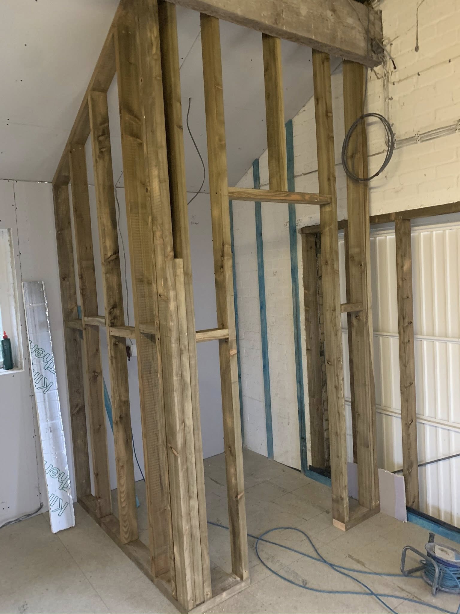 Garage conversion in progress — partition framing